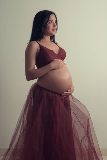 istock Dreamy pregnant lady touching stomach 1153689593
