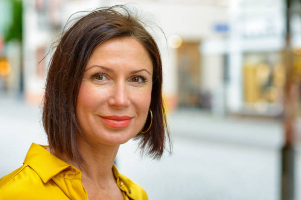 istock Attractive brunette woman smiling at the camera 1153689700
