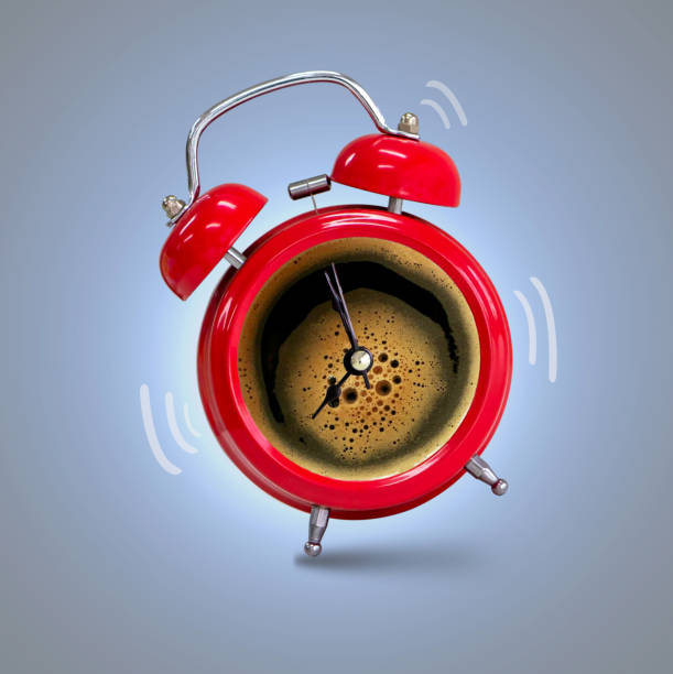 istock Alarm clock twin Bell-type red with espreso coffee background. 1153690457