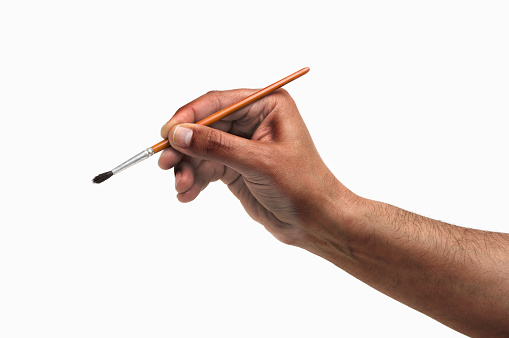 Man hand using a little paintbrush isolated on a white background