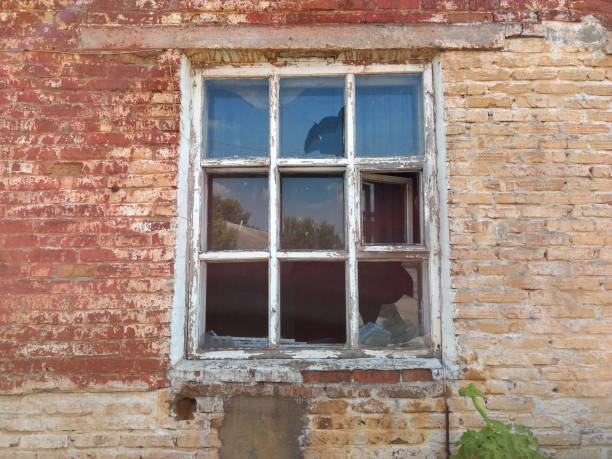 istock The broken window of the old house 1153692926