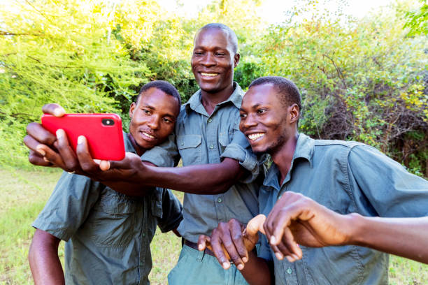 istock Group of African Forest Rangers Taking a Selfie using a Smartphone 1153694256