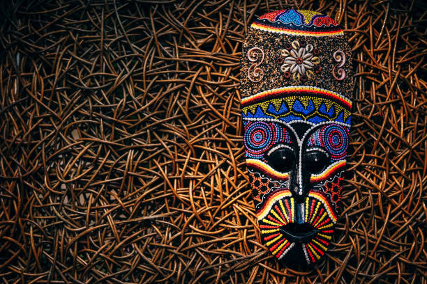 African style mask placed on a wooden background.
