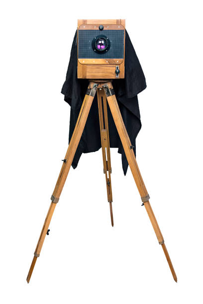old wooden camera on a tripod isolated on white background