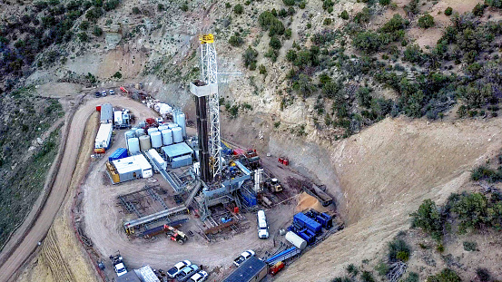 An amazing drone view of a drill rig perched on the side of a mountain in Colorado in the Springtime