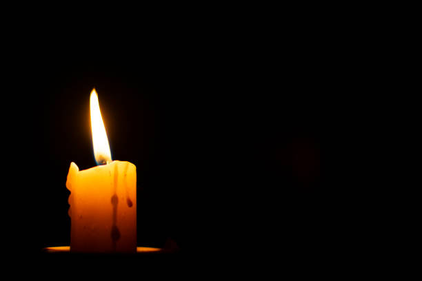 istock burning wax candle on a black background and a blank place for inscriptions 1153697769