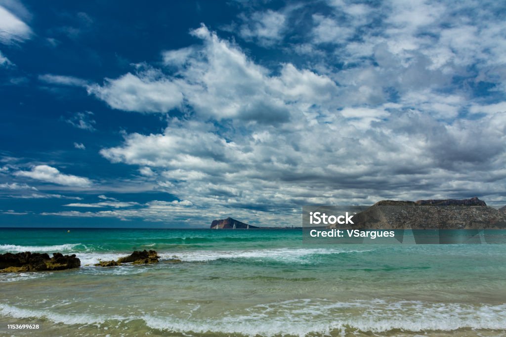 Cantal Roig beach Cantal Roig beach in Calpe, Alicante, Spain. Benidorm city at background, and some residential houses Calpe Stock Photo