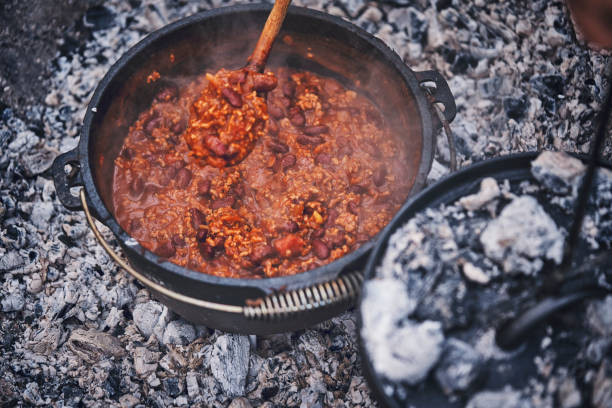 istock Cooking Chili Con Carne in Dutch Oven over Logfire 1153699833
