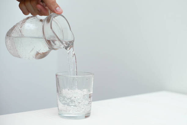 istock Man fill a glass with fresh pure water 1153701846
