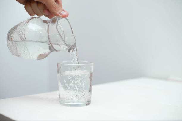 istock Man fill a glass with fresh pure water 1153701847