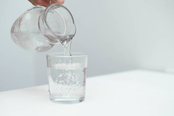 istock Man fill a glass with fresh pure water 1153701848