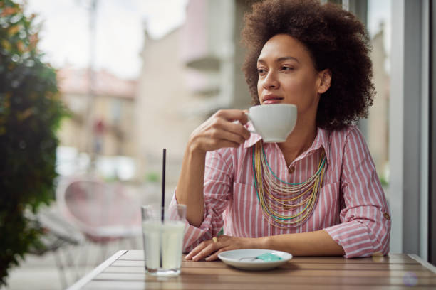 istock Woman drinking coffee in cafe. 1153702979