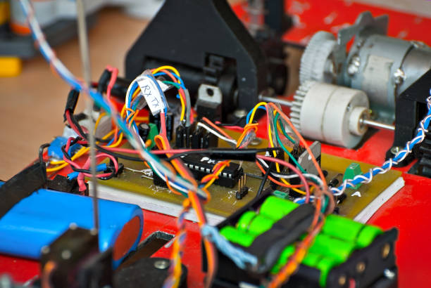 istock Electronics and robotics of handmade. Microcircuits and colored wires close up. Electronic devices and mechanisms are presented at the scientific exhibition. 1153704468