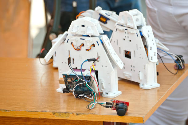 istock Robotics is made by children at a scientific exhibition. Multi-colored wires and microcircuits are made of plywood, designer and spare parts. Radio controlled devices. 1153704505