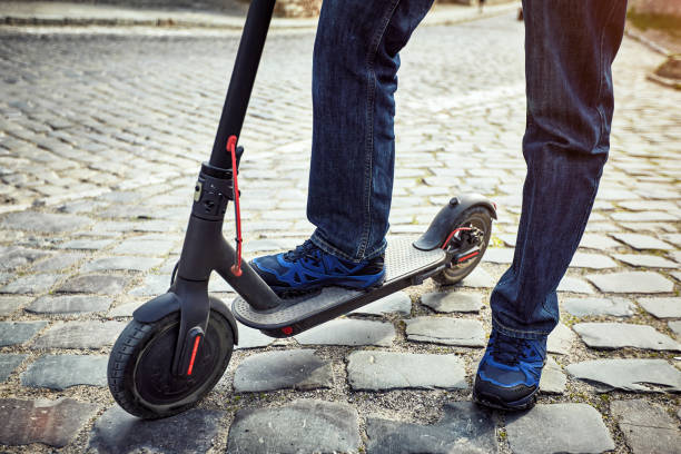 istock A man rides a scooter in the countryside in summer. 1153704664