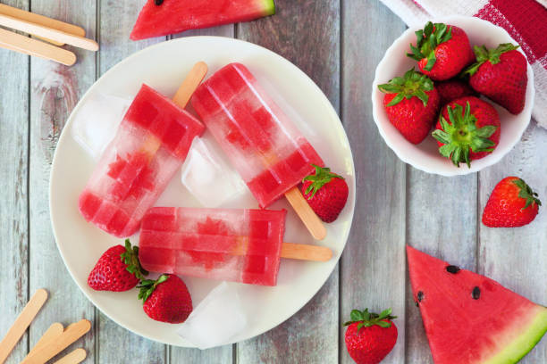 istock Canada Day flag popsicles, top view scene on a rustic wood background 1153706539