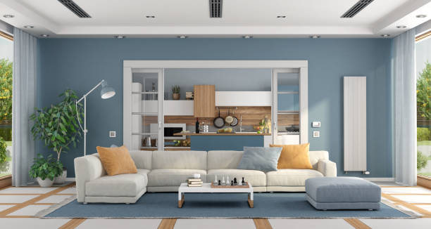 wohnzimmer mit sofa und moderner küche auf dem hintergrund - living room blue sofa carpet stock-fotos und bilder