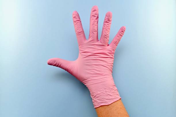 Right gloved hand with outer side of hand.