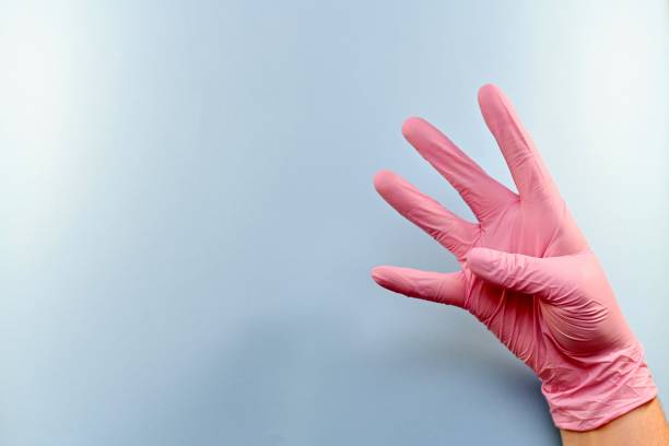 istock The right gloved hand shows four fingers. 1153707674