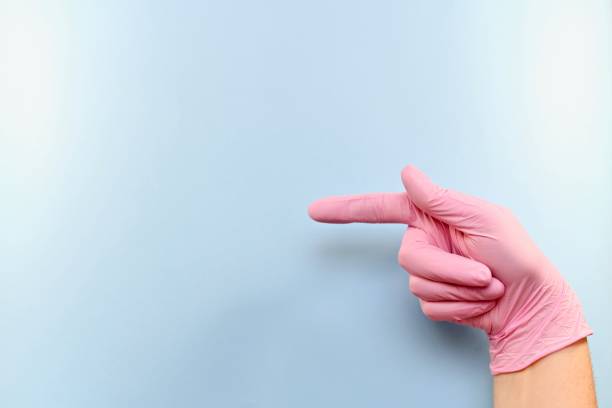 istock The right gloved hand points, or shoots, imitates a gun. 1153707704