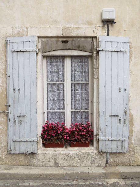 istock Old window with shutters in Provence style. White curtains. 1153710107