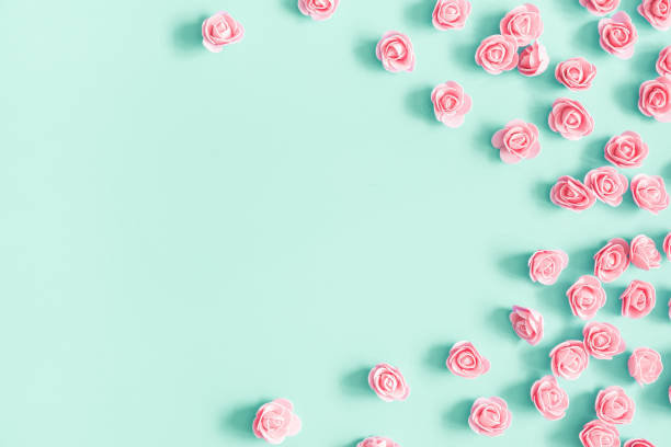 istock Flowers composition. Pink rose flowers on mint background. Flat lay, top view, copy space 1153710182