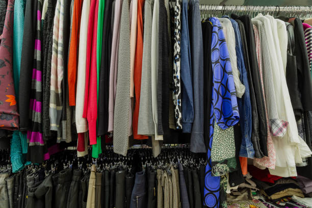istock Beautiful colorful clothes in a store on hangers 1153711253