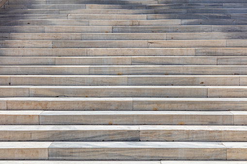 Staircase of marble. Long stairs for background. White and grey stairway, empty, close up view, details.