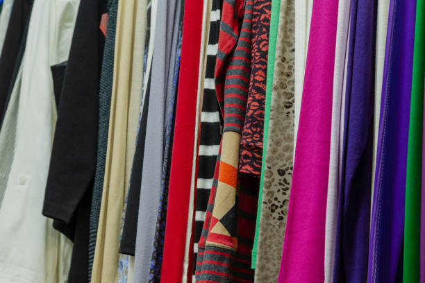 istock Beautiful colorful clothes in a store on hangers 1153711331