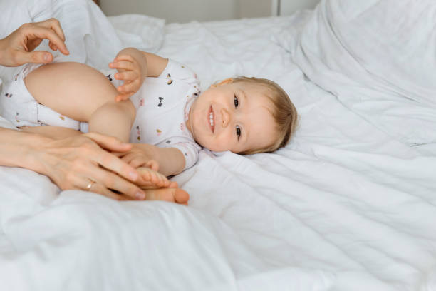 istock kid smiling and happy to be in moms hands 1153711883