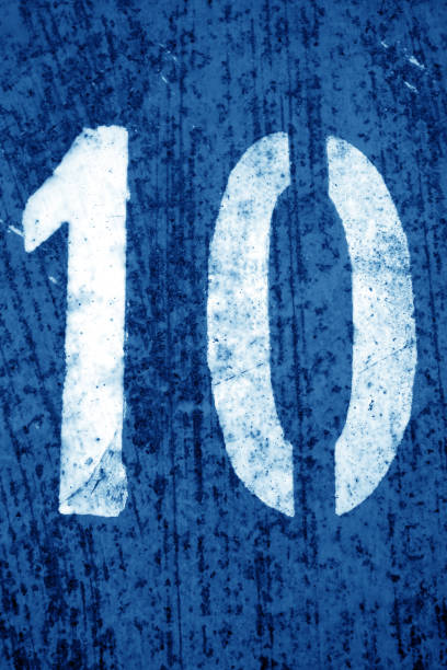 istock Number 10 in stencil on metal wall in navy blue tone. 1153713270