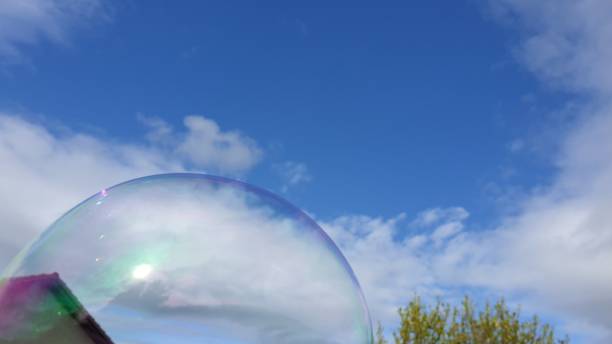 istock Soap bubble against house and bush 1153714638