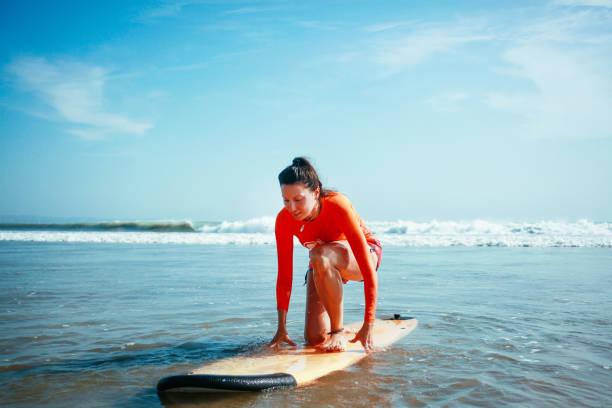 istock young woman surfing on the Bali beach 1153715588