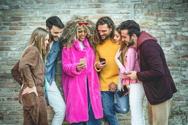 istock Group of multiracial people having fun watching a smartphone screen together 1153715815