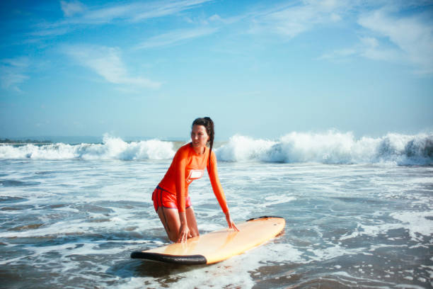 istock young woman surfing on the Bali beach 1153715937