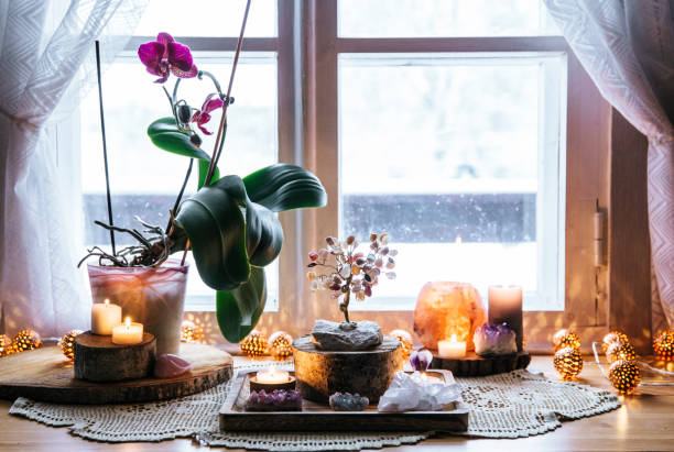 istock Feng Shui nature theme altar at home table and on window sill. Earth element( rock crystal clusters), wood element( wood discs), fire element( candles), rock salt candle holder. Positive home energy. 1153716253