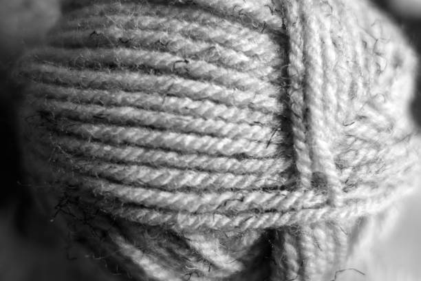 Yarn ball close-up with blur effect in black and white. Abstract background and texture for design.