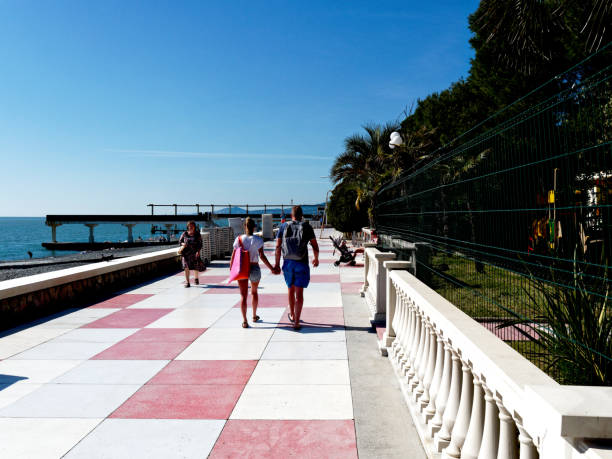 Sochi, Russia - May 16, 2019: a young couple is walking on the embankment holding hands