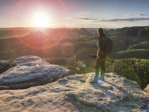 istock Photographer on mountain above valley with morning  mist 1153719634