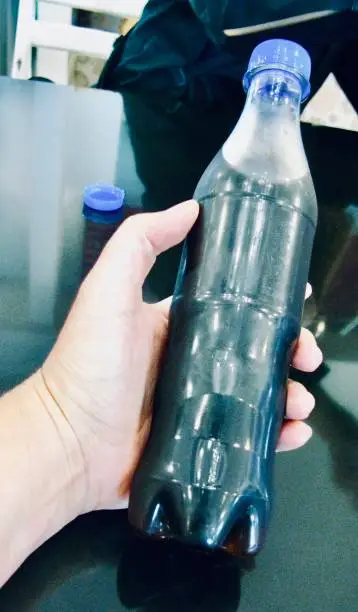 Photo of Bottle of Cola Soda Drink in A Hand