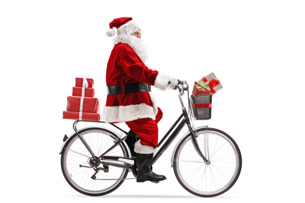 istock Santa Claus riding a bicycle and carrying presents 1153725599