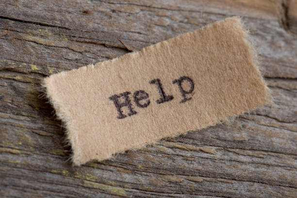 istock Help word on a piece of paper close up 1153726293