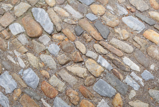 istock Old cobblestone road of big stones. 1153729606