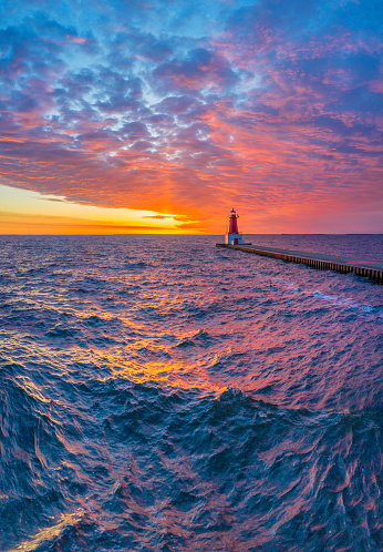 I rolled out of bed at 4 am and the sky was cloudy as far as the eye could see in every direction. But the weather app said that it would be sunny in Menominee in time for sunrise, so I drove right up there (50 miles). It was a good choice too! Check out this sunrise, and these dramatic, angry waters driven by high winds.
