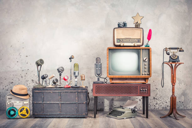 retro tv, old studio microphones, outdated broadcast radio, journalist's reel tape recorder, aged telephone, film camera, golden award star, quill, typewriter. journalism concept. vintage style photo - typewriter writing retro revival old fashioned imagens e fotografias de stock