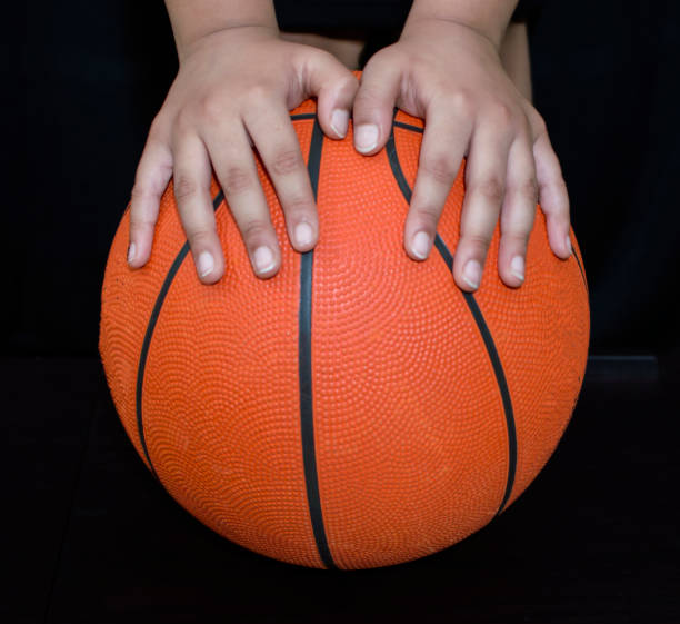 istock Basketball and the two hands on the ball 1153736006