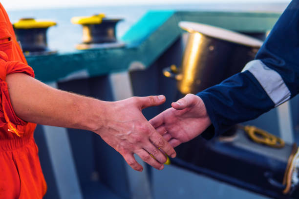 istock marine contractor businessman handshaking with worker on the ship. 1153737099
