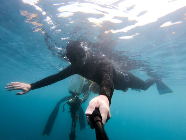 istock Diver swimming on sea surface next to a buoy 1153737124