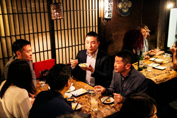 istock Co-workers eating dinner in Japanese restaurant 1153738788