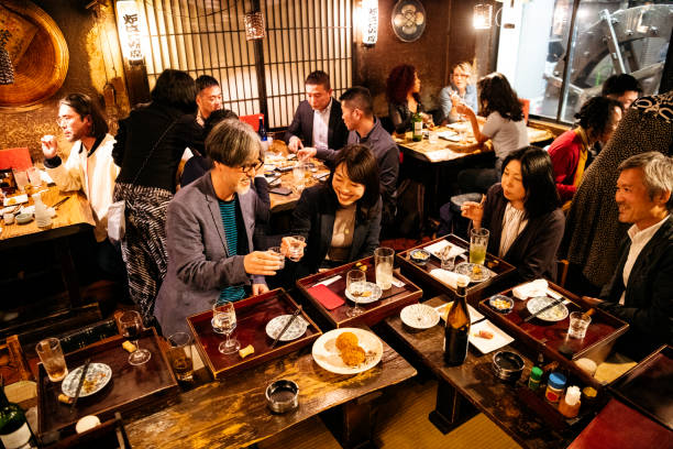 Work friends toasting each other in Japanese Izakaya